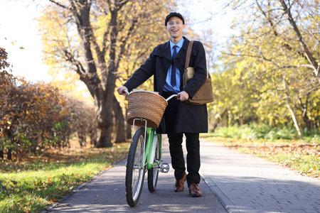Happy mailman with bicycle outdoors. Postal serviceの写真素材