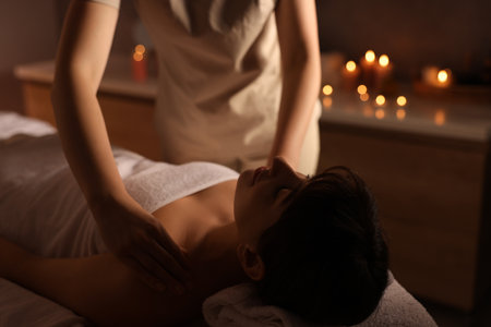 Young woman receiving massage in spa salonの写真素材