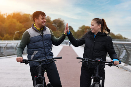 Beautiful happy couple with bicycles spending time together outdoors