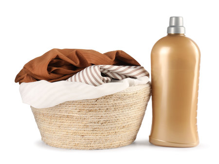 Bottle with laundry detergent and clothes in basket isolated on whiteの写真素材