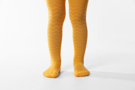 Child wearing bright tights on white background, closeupの写真素材