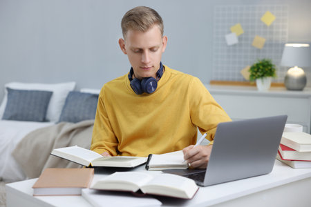 Student preparing for exam at table indoors