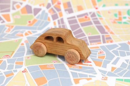 Wooden toy car on city map. Road tripの写真素材