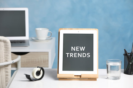 New trends. Modern tablet and stationery on white deskの写真素材