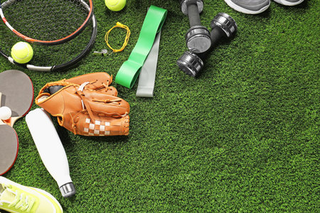 Different sports equipment on artificial grass, flat lay. Space for textの写真素材