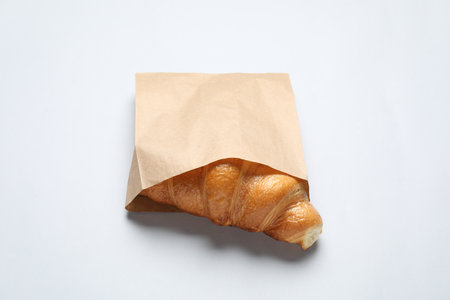 Paper bag with fresh croissant on white backgroundの写真素材