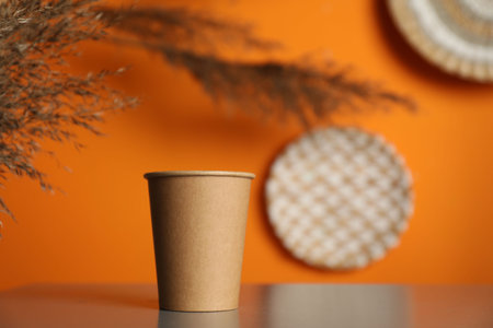 Paper cup on grey table indoors. Mockup for designの写真素材