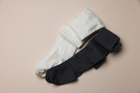 Different child's tights on beige background, top viewの写真素材