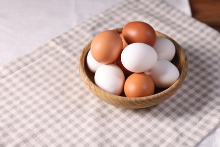 Fresh eggs in bowl on table, closeup. Space for textの写真素材