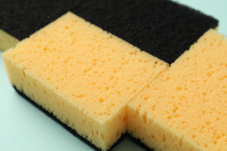 Color sponges on light blue background, closeupの写真素材