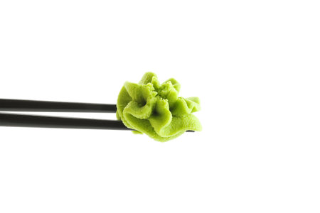 Chopsticks with hot wasabi paste isolated on whiteの写真素材