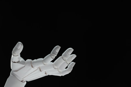 Artificial intelligence. Robot hand gesturing on black background, space for textの写真素材