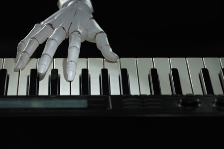Artificial intelligence. Robot hand playing synthesizer on black background, closeup
