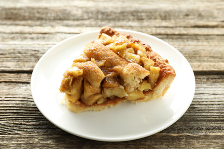 Slice of homemade apple pie on wooden tableの写真素材