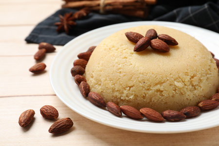 Delicious semolina halva with almonds on white wooden table, closeupの写真素材
