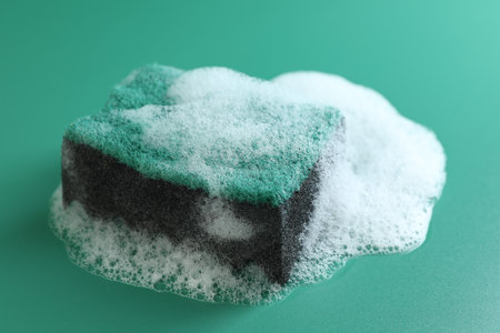 One sponge in foam on green background, closeupの写真素材