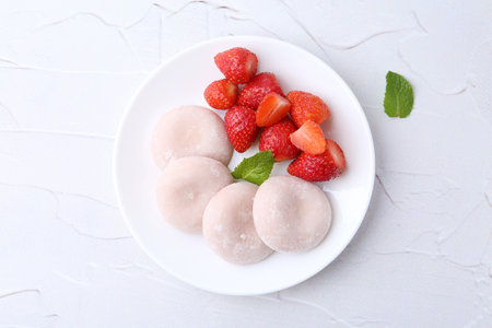 Delicious mochi and strawberries on white table, top viewの写真素材
