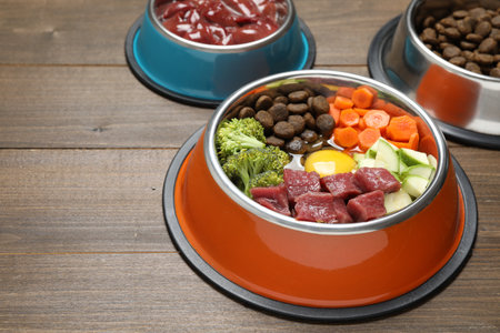 Dry pet food and natural products on wooden table, closeupの写真素材