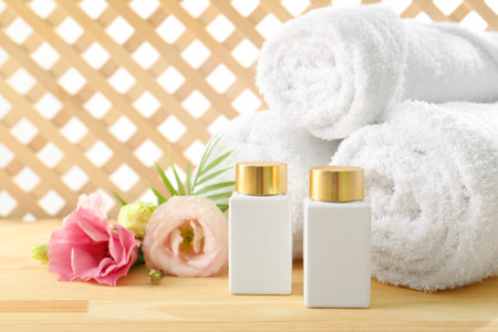 Composition with cosmetic products for spa treatment on wooden table