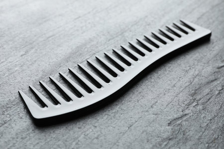 One plastic hair comb on gray table, closeupの写真素材