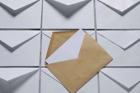 Paper envelopes with letter on gray background, top view. Mockup for designの写真素材