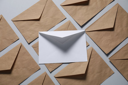 Paper envelopes on gray background, flat lay. Mockup for designの写真素材