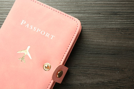 Passport in pink cover on wooden table, top view. Space for textの写真素材