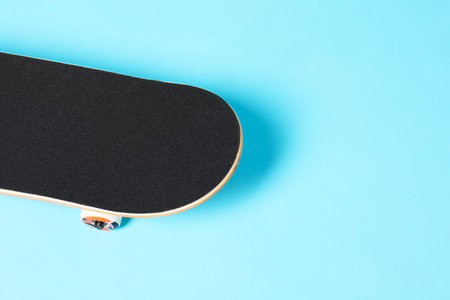 One skateboard on light blue background, space for text. Sports equipmentの写真素材
