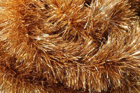 Shiny golden tinsel as background, closeup viewの写真素材