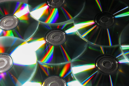 Many shiny compact discs as background, closeup