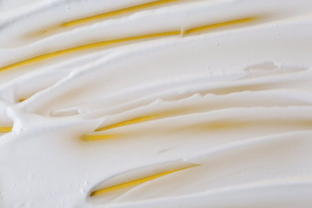 Sample of fluffy foam on orange background, top viewの写真素材