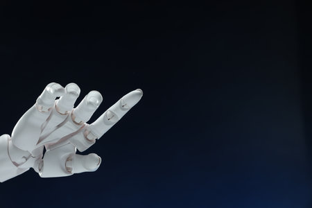 Artificial intelligence. Robot hand pointing at something on dark blue background, space for textの写真素材