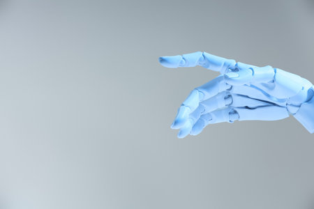 Artificial intelligence. Robot hand gesturing on grey background, space for textの写真素材