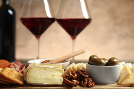 Different types of delicious cheese, other snacks and wine on table, closeupの写真素材