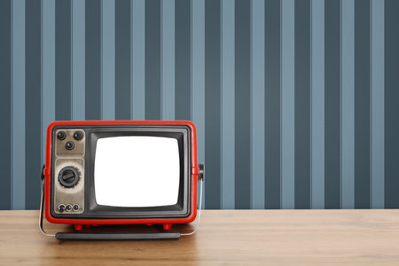 Retro TV on wooden table near wall with vintage style wallpaper. Space for textの写真素材