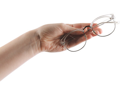 Woman holding glasses with stylish transparent frame on white background, closeupの写真素材