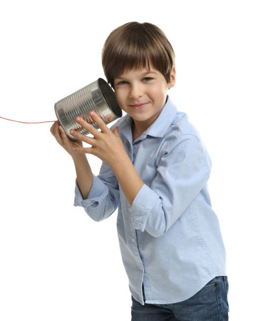 Boy using tin can telephone on white backgroundの写真素材