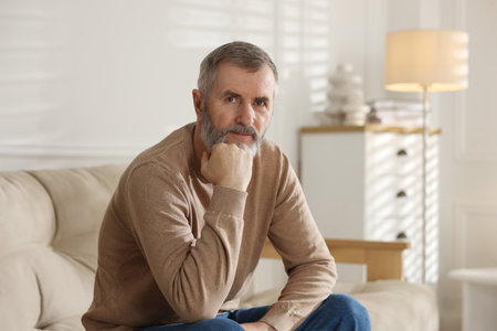 Portrait of handsome senior man at home