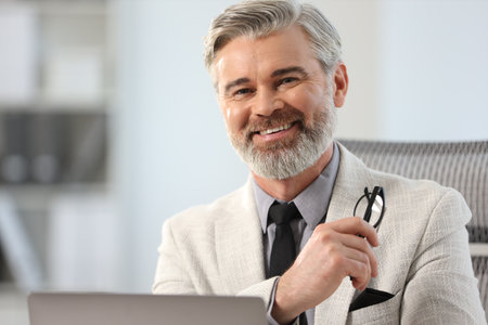 Portrait of banker with glasses in office, space for textの写真素材