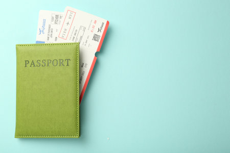 Passport with tickets on light blue background, top view. Space for textの写真素材