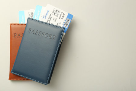 Passports with tickets on light background, top view. Space for textの写真素材