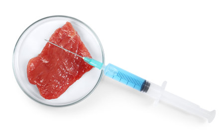 Piece of meat and syringe isolated on white, top viewの写真素材