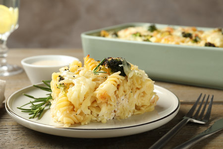 Tasty pasta casserole with cheese and broccoli served on wooden table, closeupの写真素材