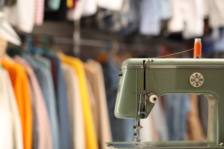 Vintage sewing machine with thread in workshop. Space for textの写真素材