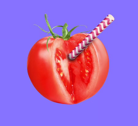 Drinking straw sticking out of fresh tomato on violet background. Freshly made juice or smoothie conceptの写真素材