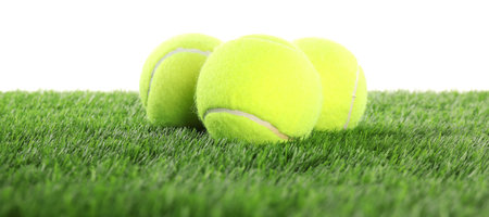Tennis balls on artificial grass isolated on white. Sport equipmentの写真素材