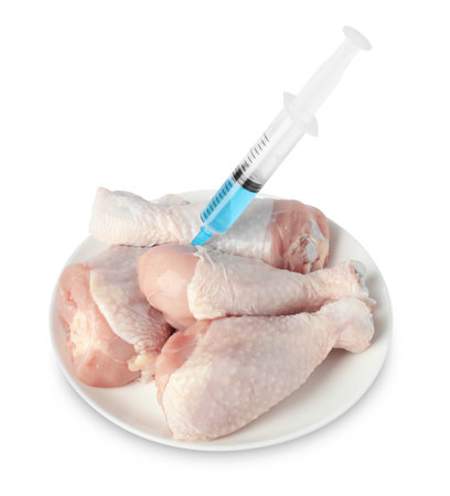 Chicken drumsticks and syringe isolated on whiteの写真素材