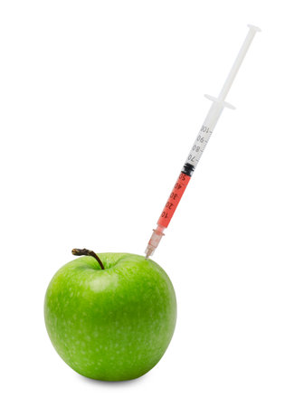 GMO concept. Fresh apple and syringe isolated on whiteの写真素材