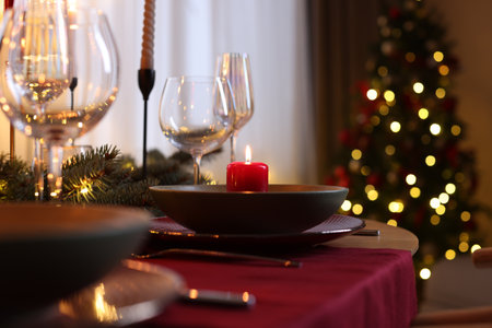 Festive table setting in room decorated for Christmas, closeup. Bokeh effectの写真素材