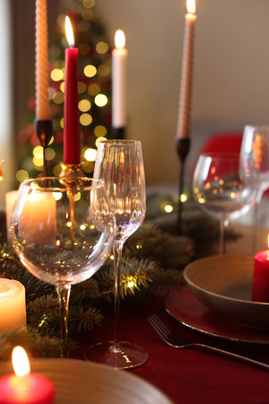Festive table setting in room decorated for Christmas, closeup. Bokeh effectの写真素材